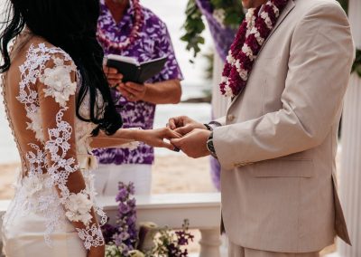 Nhu's husband placing the ring on her finger