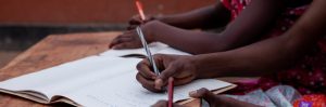Children writing in notebooks