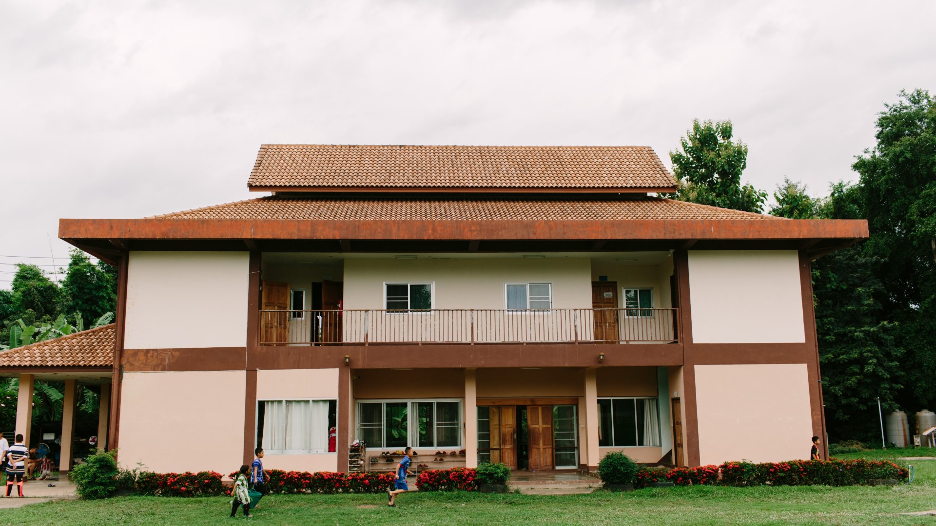 A group of people standing in front of a home