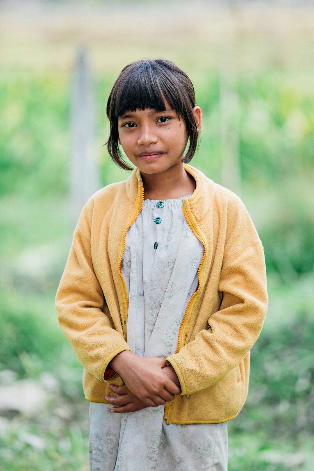 A girl standing in a field.